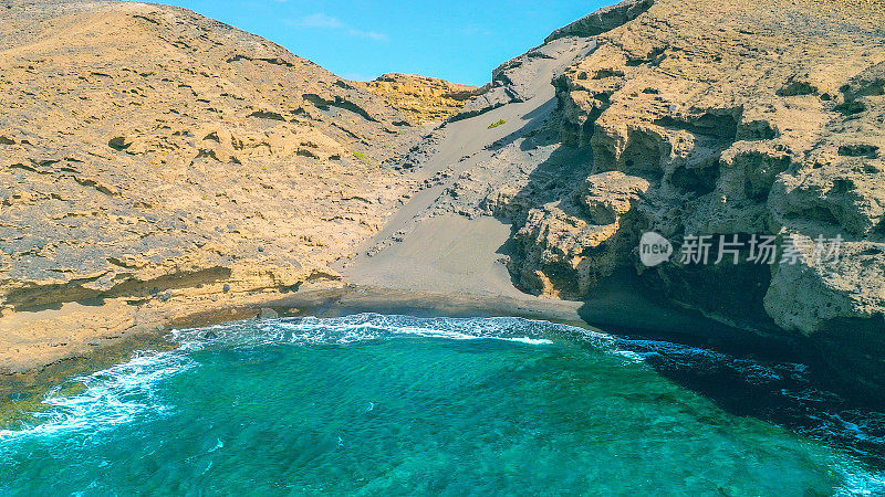 Aerial view of the hidden cove beach "La Rajita" at the natural reserve of "Monta?a Pelada" in Tenerife (Canary Islands). Drone shot